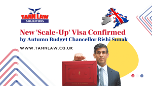 Advertisement for Tann Law Solicitors with an image of a man holding a red briefcase. Text mentions a new "Scale-Up" visa confirmed by the Autumn Budget Chancellor.