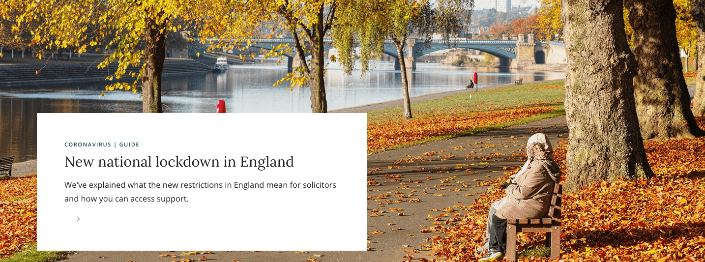 An elderly person sits on a bench in a park with autumn leaves, near a river. There's a notice about a new national lockdown in England on the left side of the image.