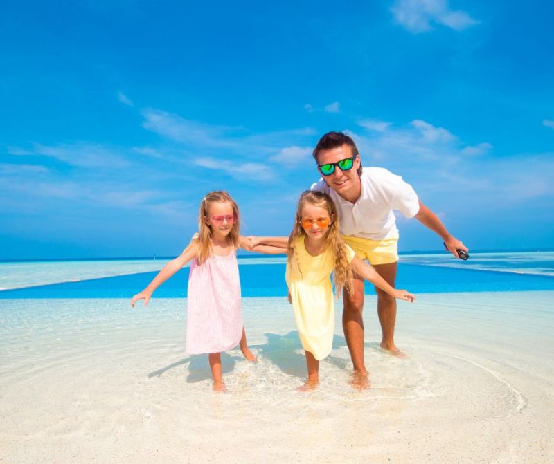 parent and children at the beach