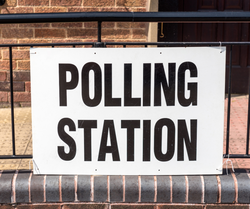 polling station sign on railings