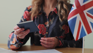 handing British passport with United Kingdom flag