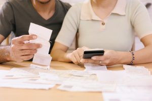 man and woman couple pay electricity and rent bills. African American young married person