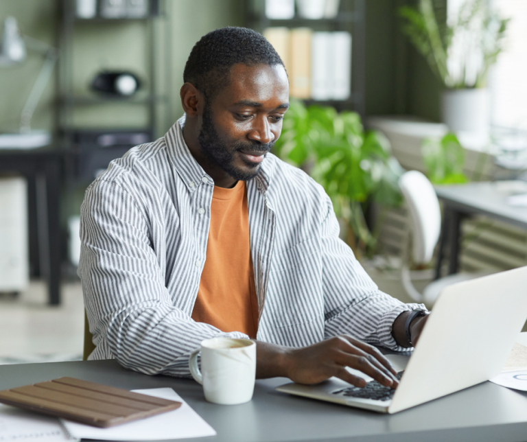 Business professional using the Sponsor Management System (SMS) to support sponsor licence compliance and manage sponsored workers in the UK.