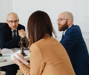 Solicitors discussing a legal dispute with a client, illustrating the civil litigation meaning and process for resolving disputes through legal action.